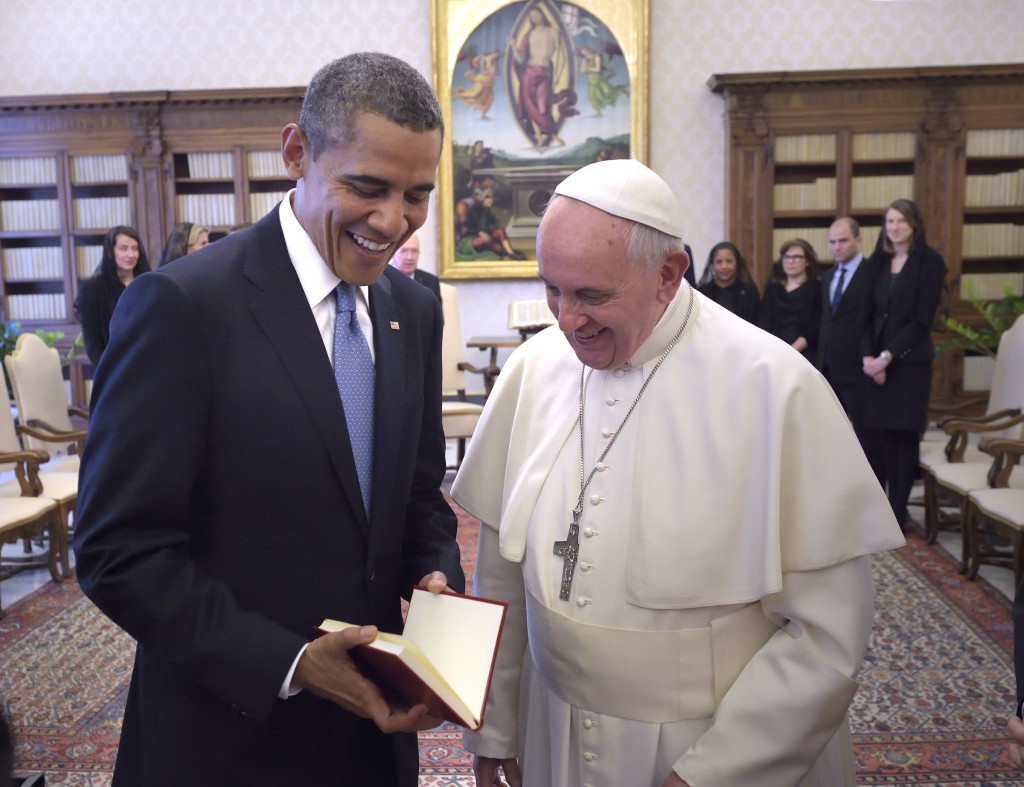 U.S. President Barack Obama accepts a gift from Pope Francis during a private audience at the Vatican March 27. The pope gave the president a copy of his apostolic exhortation, "Evangelii Gaudium". PHOTO: CNS/Stefano Spaziani, pool