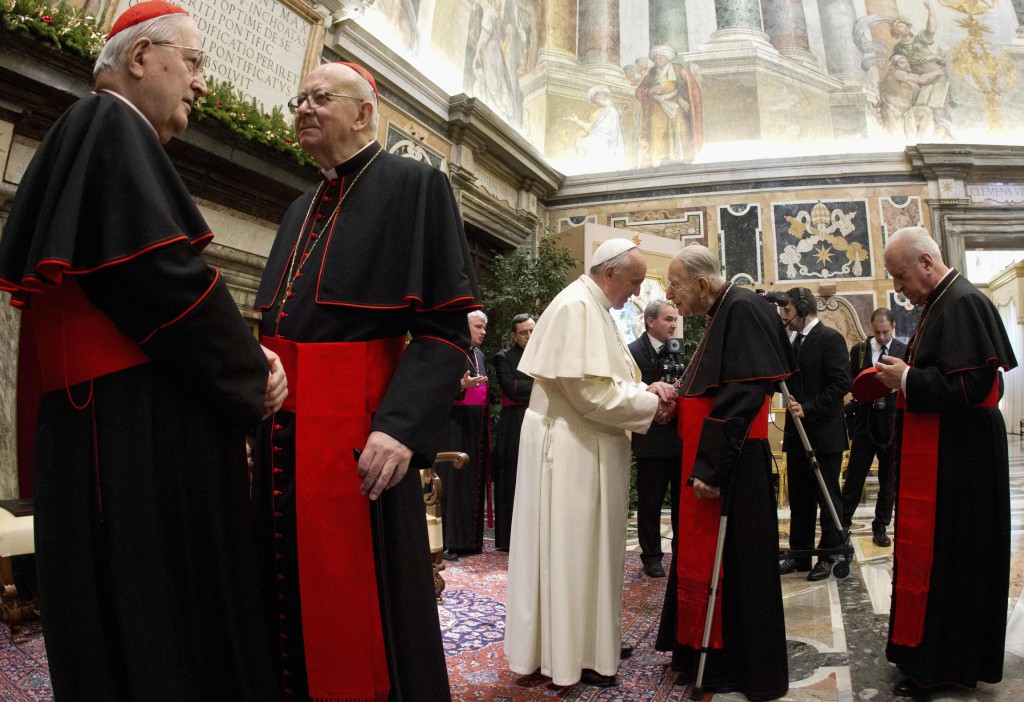 Pope Francis greets Cardinal Georges Cottier during an audience to exchange Christmas greetings with members of the Roman Curia in Clementine Hall at the Vatican Dec. 21. Also pictured from left are Cardinals Angelo Sodano, Attilio Nicora and Franc Rode. PHOTO: CNS/Claudio Peri, pool via Reuters