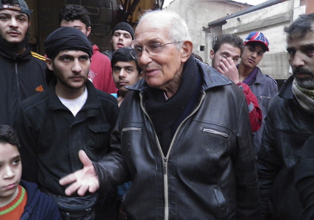 Jesuit Father Frans van der Lugt chats with civilians in early January, urging them to be patient, in the besieged area of Homs, Syria. The Jesuits said April 7 that the Dutch priest, who had worked in Syria since 1966, was beaten by armed men and killed with two bullets to the head. PHOTO: CNS/Thaer Al Khalidiya, Reuters