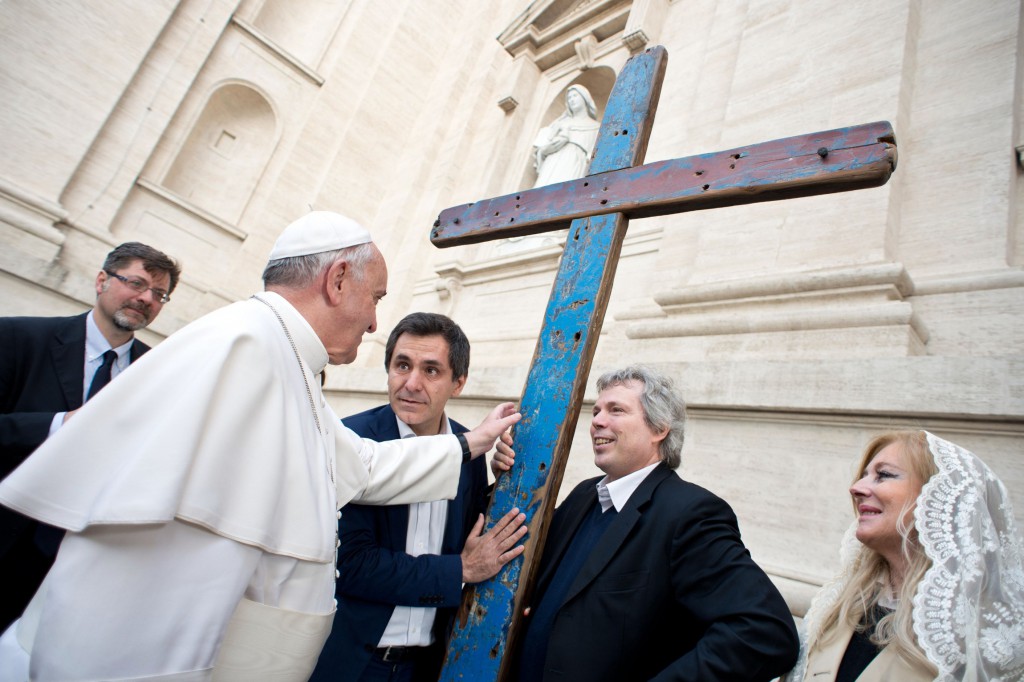 Pope Francis blesses a cross during his weekly audience at the Vatican April 9. The cross is made from wooden boards recovered from the wreckage of boats carrying migrants from northern Africa to Lampedusa, Italy's southernmost island. PHOTO: CNS/L'Osservatore Romano via Reuters