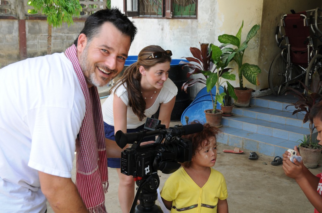 Tori Anderson, centre, who initiated the film Corridors of Children, pictured with a child in Thailand and the film’s director, Cam Smeal.