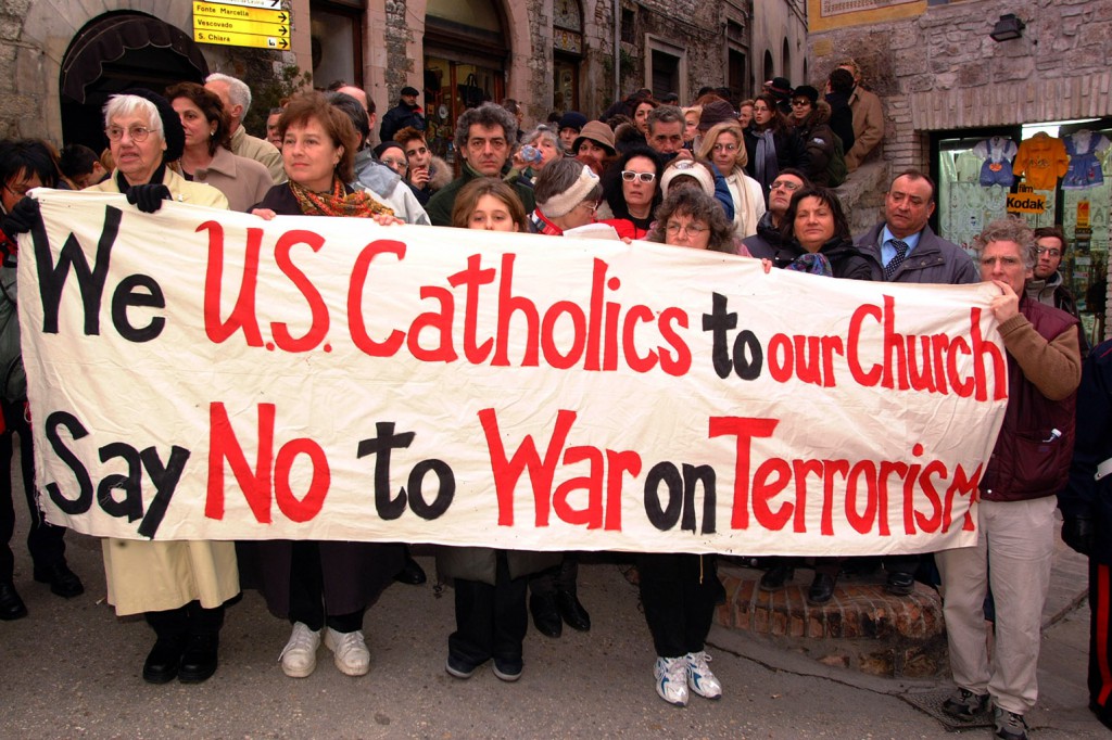 Demonstrators hold a banner in January 2002 asking the U.S. church to "say no" to the war on terrorism in Assisi, Italy. PHOTO: CNS/Alessia Giuliani, Catholic Press