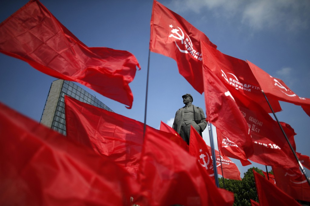 Participants wave communist flags near a statue of Soviet leader Vladimir Lenin during an International Worker's Day, or Labour Day, parade in Donetsk, east Ukraine. PHOTO: REUTERS/Marko Djurica 