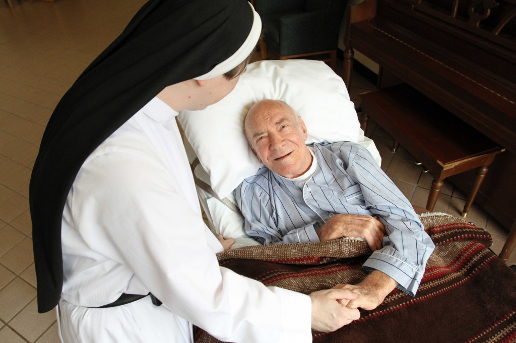 A Dominican sister in New York cares for an elderly patient suffering from a terminal illness. PHOTO: GREGORY SHEMITZ