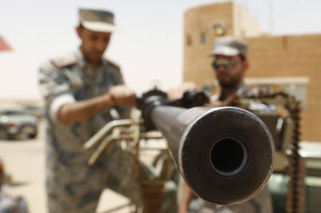 Members of the Saudi border guard hold a machine gun mounted on a military truck positioned on Saudi Arabia's northern border with Iraq July 14.  Iraqi officials confirmed reports of mistreatment of Iraqi minorities in the areas controlled by Islamist militants of the Islamic State of Iraq and the Levant, who control vast swathes of territory across five Iraqi provinces north and west of the Iraqi capital, Baghdad. PHOTO: CNS/Faisal Nasser, Reuters