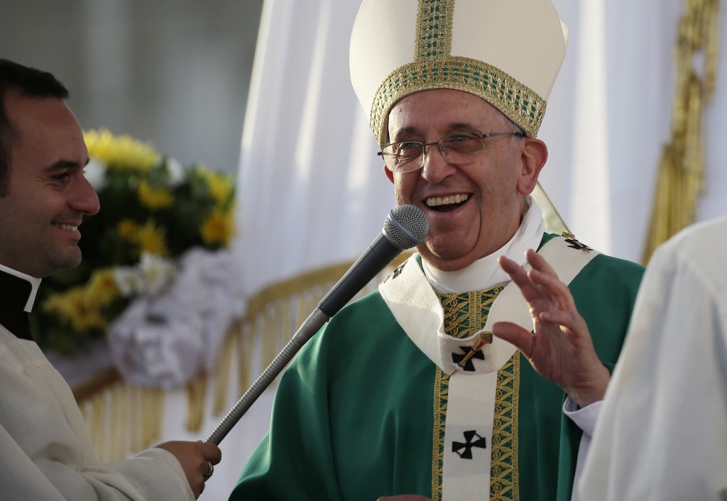 Pope Francis smiles as he celebrates Mass at the Royal Palace of Caserta in Italy July 26. He spoke about resisting the mafias evil ways and protecting the environment. PHOTO: CNS/Max Rossi, Reuters