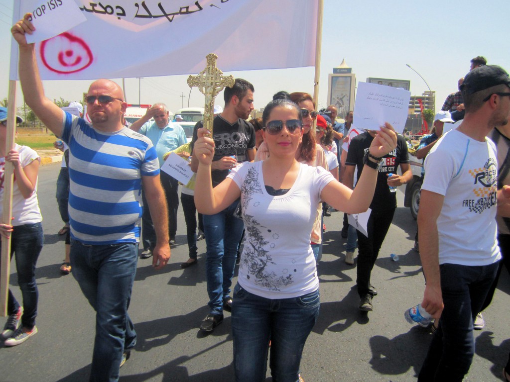 Christian refugees march against persecution by Islamic State fighters outside the U.N. compound near the airport in Irbil, Iraq, July 24. Christians braved temperatures as high as 122 degrees Fahrenheit to make their voices heard. PHOTO: CNS/Sahar Mansour