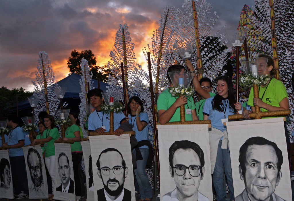 Students of the Central American University Jose Simeon Canas hold portraits of the six Jesuit priests from Spain, that were killed by the Salvadoran Army during the civil war in 1989, as they participate in a tribute ceremony in the 21st anniversary of their execution in San Salvador, El Salvador, Saturday Nov. 13, 2010. PHOTO: AP/Edgar Romero