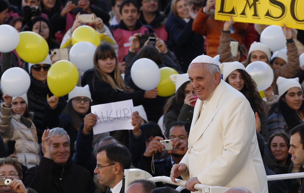 Balloons and a sign wish Pope Francis happy birthday as he arrives to lead his general audience in St. Peter's Square at the Vatican Dec. 17, the pope's 78th birthday. PHOTO: CNS/Paul Haring