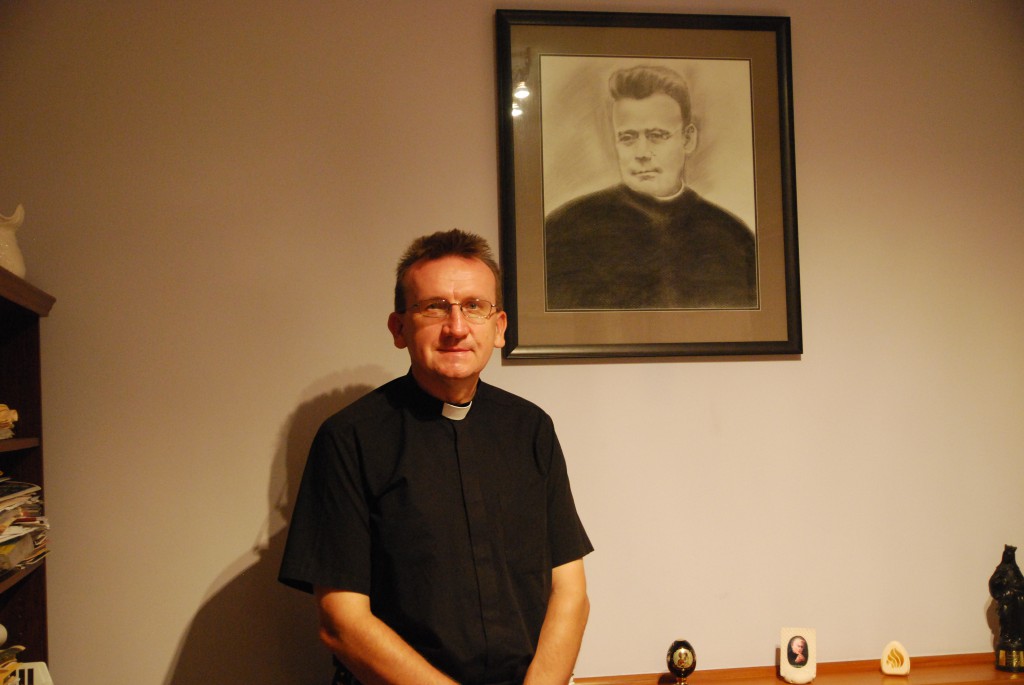 Fr Irek Czech SDS stands beside a portrait of the founder of his order Francis Mary of the Cross Jordan. PHOTO: Marco Ceccarelli