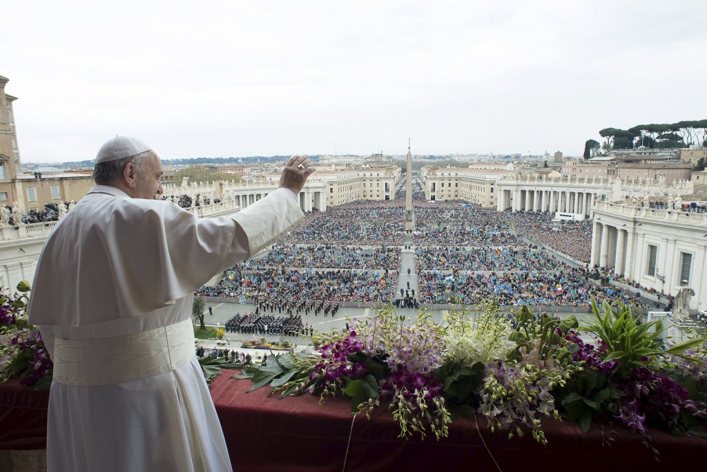 Pope Francis waves to the crowd during his Easter message and blessing "urbi et orbi" (to the city and the world) from the central balcony of St. Peter's Basilica at the Vatican April 5. PHOTO: CNS/L'Osservatore Romano via Reuters