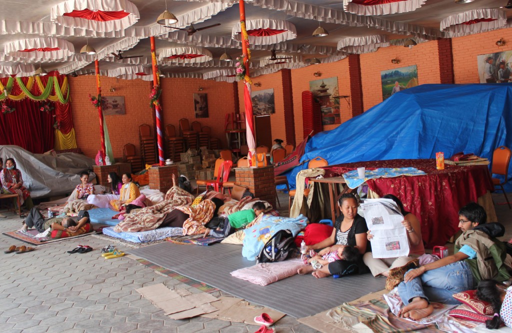 Many Nepal residents of shaken apartment building in Lalitpur gather in a nearby banquet hall May 13 out of fear their building will collapse. The second major earthquake in less than three weeks in Nepal has spread renewed fears and dented the confidence of people, church and charity workers have said. PHOTO: CNS/Anto Akkara