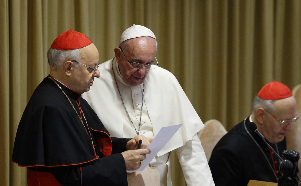 Pope Francis looks at a document with Italian Cardinal Lorenzo Baldisseri, general secretary of the Synod of Bishops, before the morning session of the extraordinary Synod of Bishops on the family at the Vatican on 9 October 2014. PHOTO: CNS/Paul Haring