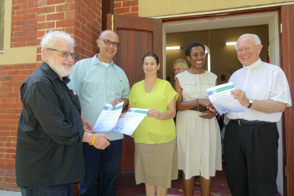 Fr Paul Pitzen from the Emmanuel Centre presents MHFA certificates to Albert, an Emmanuel Centre volunteer, and Jenny, who is profoundly deaf. Monsignor Michael Keating presents a MHFA certificate to Grace, one of his parishioners at St Mary’s Cathedral. PHOTO: Supplied