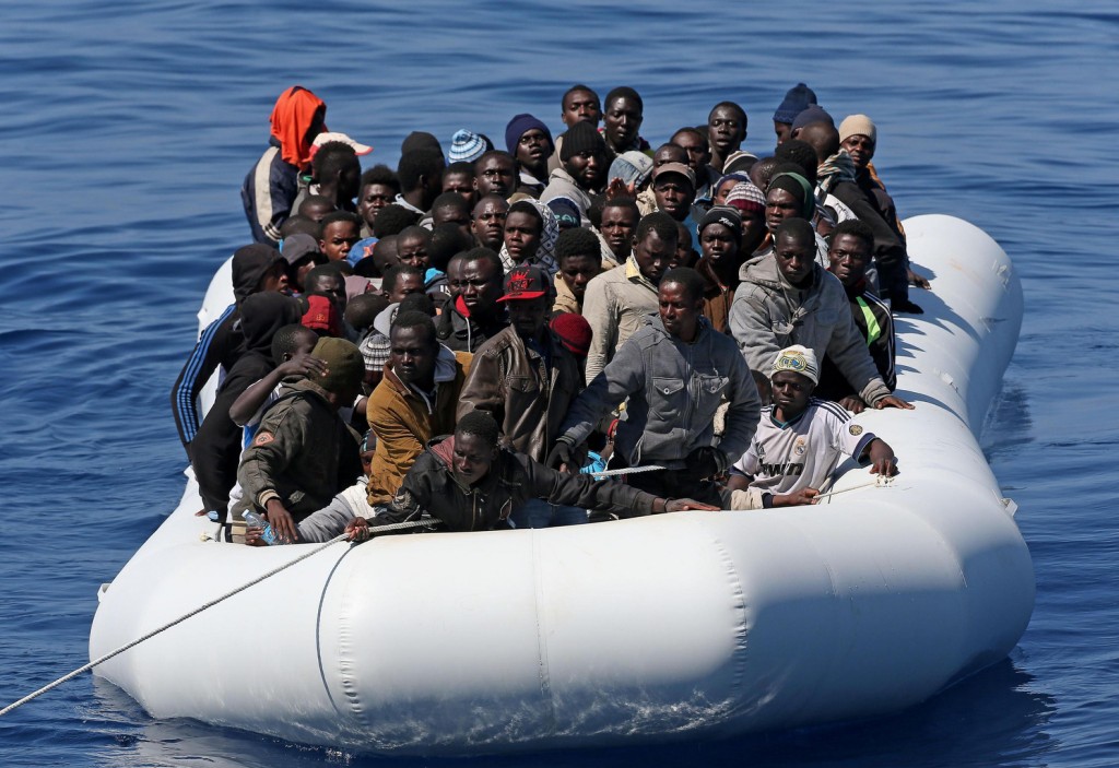 Migrants are seen in a boat after being rescued in late April in the Mediterranean Sea. Abortion, abandoning migrants at sea, unsafe working conditions, malnutrition, terrorism and euthanasia are all "attacks on life," said Pope Francis. PHOTO: CNS/Alessandro Di Meo, EPA