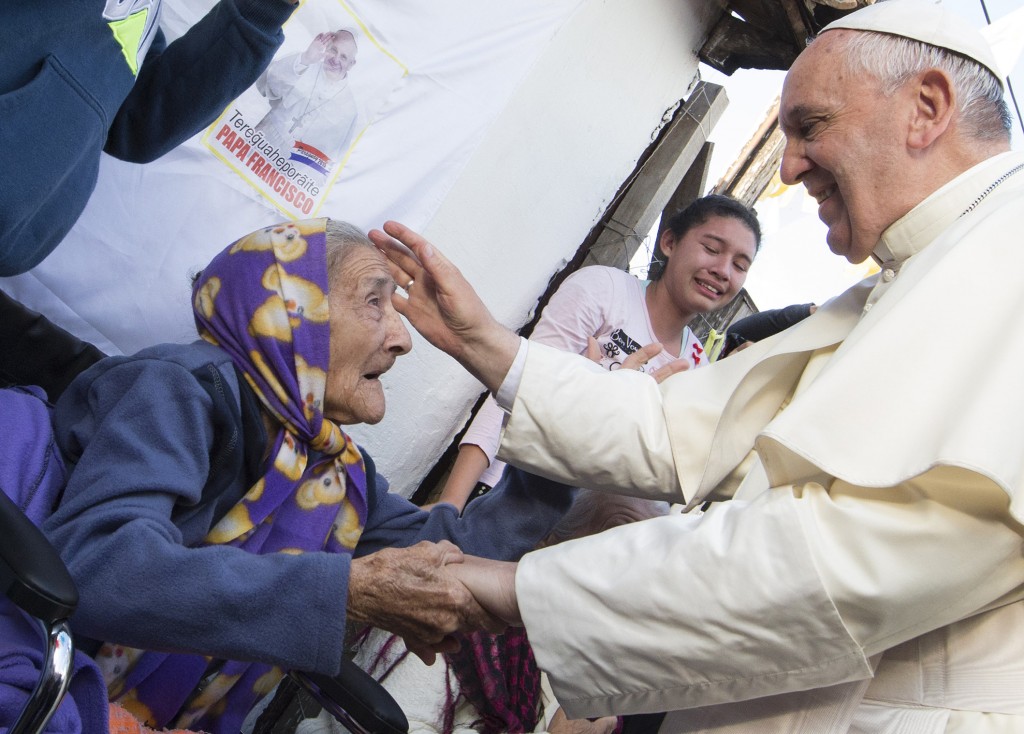 Pope Francis greets an elderly woman as he meets with people of Banado Norte, a poor neighbourhood in Asuncion, Paraguay, on 12 July. PHOTO: CNS /Paul Haring