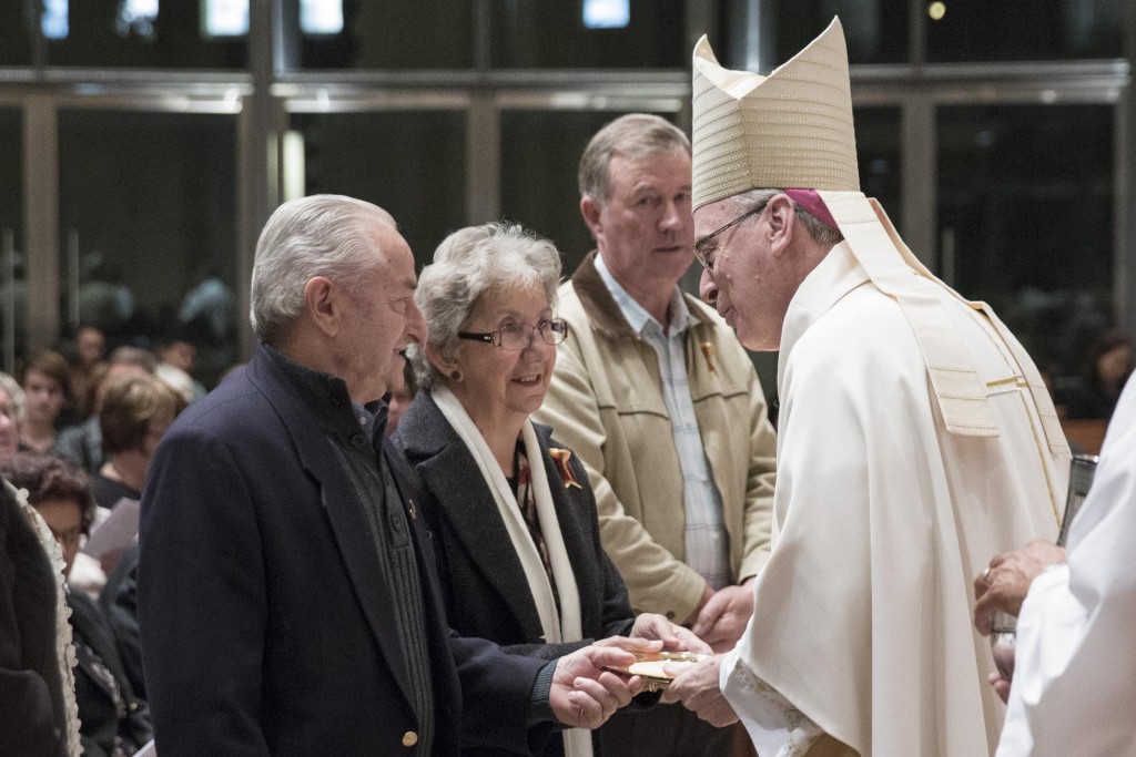 Auxiliary Bishop Don Sproxton receives the gifts from married couple during the Annual Marriage Day Mass at St Mary's Cathedral on August 18, 2014. PHOTO: Ron Tan Photography
