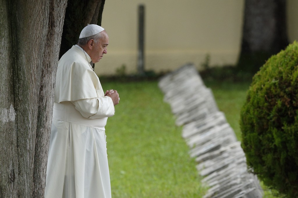 Pope Francis is shown praying at an Austro-Hungarian cemetery for fallen soldiers of World War I in Fogliano di Redipuglia, northern Italy, on 13 September 2014. In his encyclical Laudato Si' on Care for Our Common Home, released on 18 June, the Pope said all Creation is singing God's praise but people are silencing it. PHOTO: Paul Haring