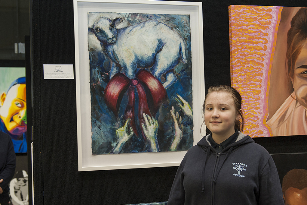 Fra Angelico Award winner Elhanna Glock from St Clare’s school in Lathlain stands next to “The Gift” - the piece that won her a prestigious award. PHOTO: Supplied