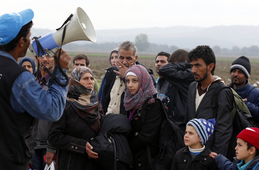 Refugees listen to a translator as they arrive at a transit camp in Idomeni, Greece, on the border of Macedonia, on October 19. Thousands of refugees are arriving into Greece from Syria, Afghanistan, Iraq and other countries and then traveling further into Europe. Photo: CNS.