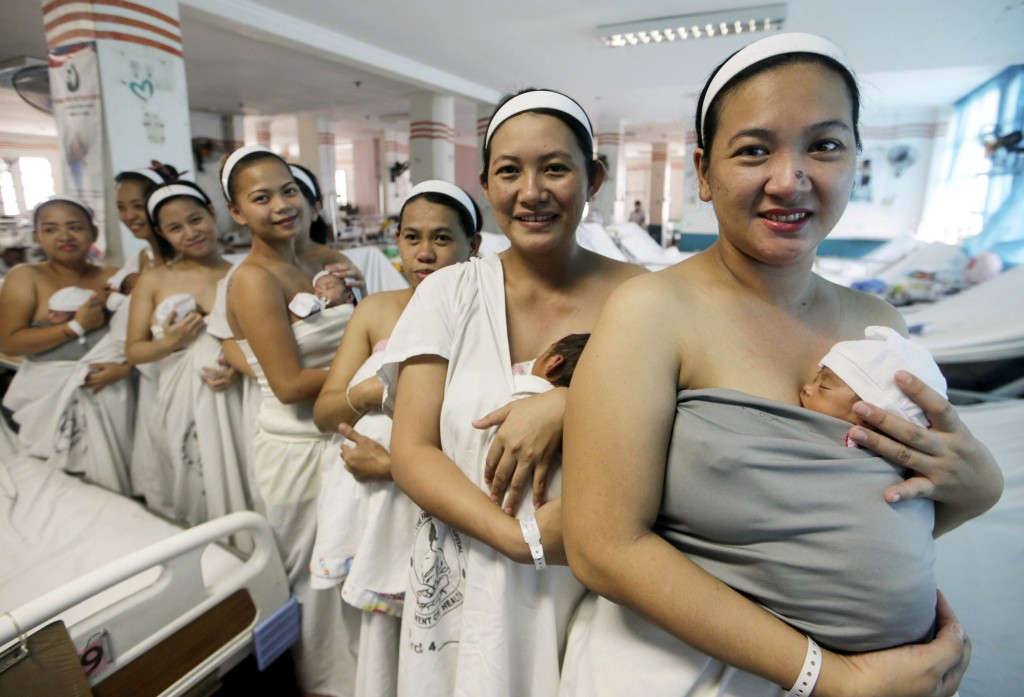 Filipino mothers hold their newly born babies in Manila, March 4. Pope Francis said businesses are called to promote harmony between work and family for their employees, especially for women with children or who are starting families. (CNS photo/Ritchie B. Tongo, EPA) See POPE-WORK-MATERNITY Nov. 2, 2015.