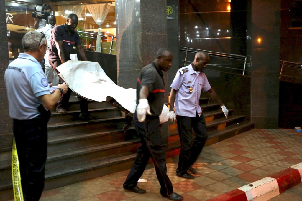 Officials carry a body outside the Radisson Hotel in Bamako, Mali, on 20 November. At least 22 people were killed that day when gunmen raided the hotel and held 170 people hostage. Photo: CNS.