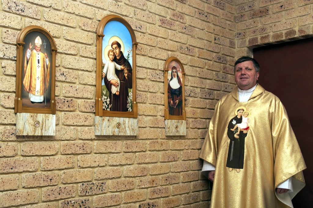 Parish priest at St Anthony’s, Greenmount, Fr Bronek Pietrusewicz SDS, stands next to the newly installed relics of St Anthony of Padua, St John Paul II and St Mary MacKillop. Photo: Marco Ceccarelli.