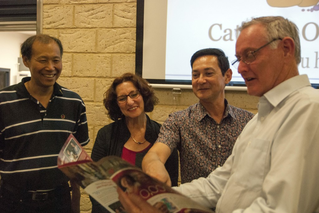 From left, parish priest of St Emilie de Vialar, Canning Vale, Fr Chien Nguyen; Catholic Outreach Officer Betty Thompson; assistant priest, Fr Anibal Leite da Cunha and Catholic Outreach Director Peter Mc Minn discuss the last issue of the LifeLink newsletter, which prominently featured Catholic Outreach as one of LifeLink’s supported agencies. Photo: Marco Ceccarelli