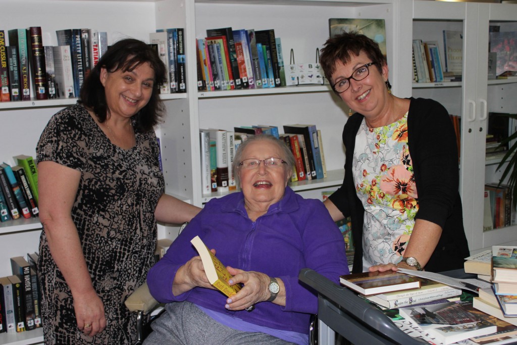 Local not-for-profit organisation MercyCare is shining a spotlight on a volunteer program supporting elderly readers ahead of state-wide Seniors Week celebrations. From left, CEWA librarians Marianne, MercyCare resident Kath, and CEWA librarian Vicki. Photo: Supplied