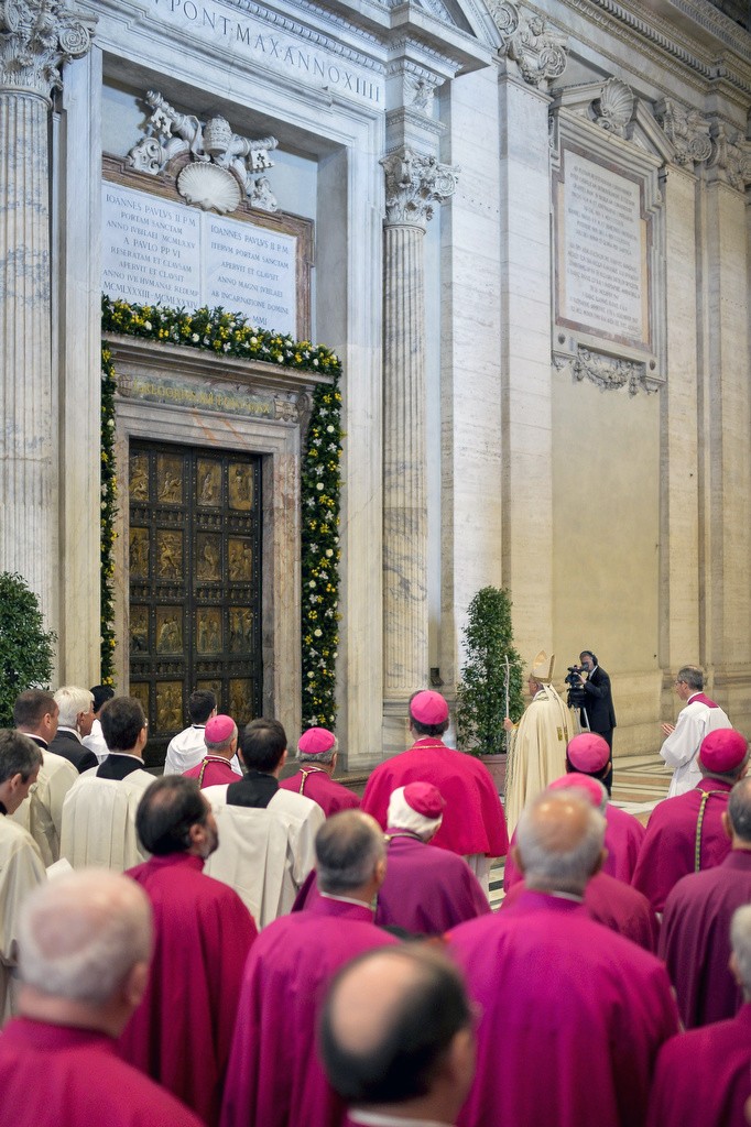 Pope Francis stands in front of the Holy Door in early April prior to first vespers of Divine Mercy Sunday in St Peter's Basilica at the Vatican. The Pope says he wants the Year of Mercy to usher in a "revolution of tenderness". Photo: CNS
