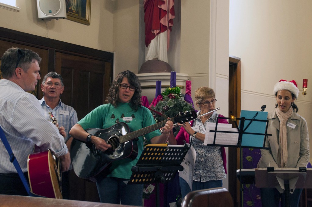 A band plays some of the more popular religious Christmas Carols within St Francis Xavier Church at the Emmanuel Centre Christmas Party 2015. Photo: Marco Ceccarelli