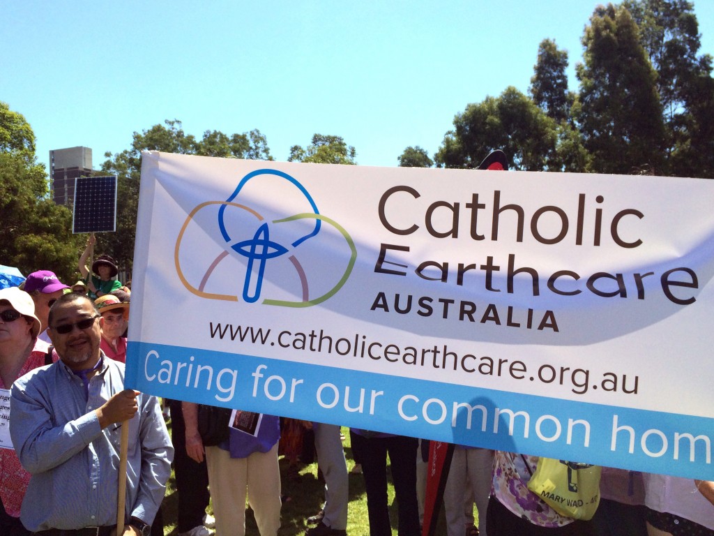 Francis Leong from Catholic Mission holds the Catholic Earthcare Australia banner. Photo courtesy Carol Mitchell