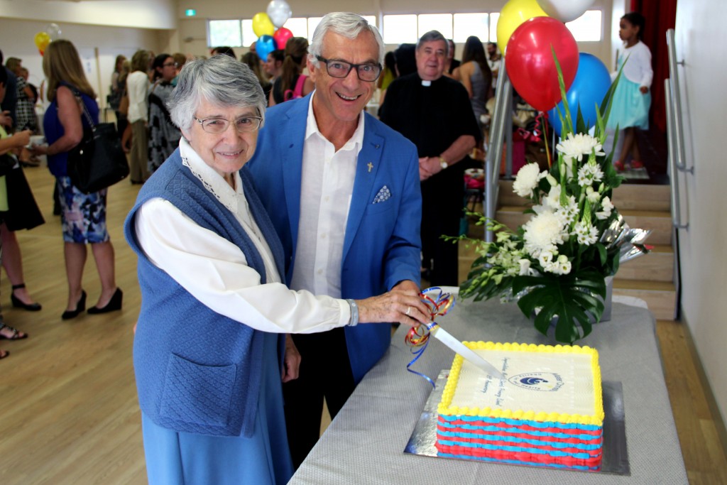 Sr Emmanuel and Fr Peter Bianchini cut the anniversary cake while Fr Bryan Rosling looks on. Photo: Supplied.