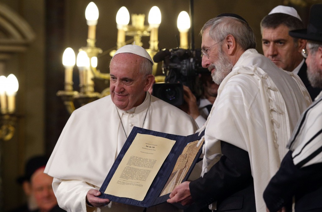 Pope Francis and Rabbi Riccardo Di Segni, the chief Rabbi of Rome, hold a codex containing five pages of Jewish biblical commentary during the Pope's visit to the main synagogue in Rome on 17 January. The 14th century codex was the Pope's gift to the Jewish community of Rome. Photo: CNS.