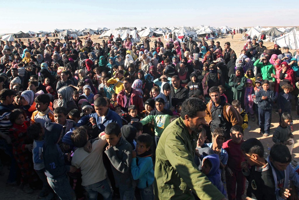 Syrian refugees wait at the border on 13 January near Royashed, Jordan. Photo: CNS.