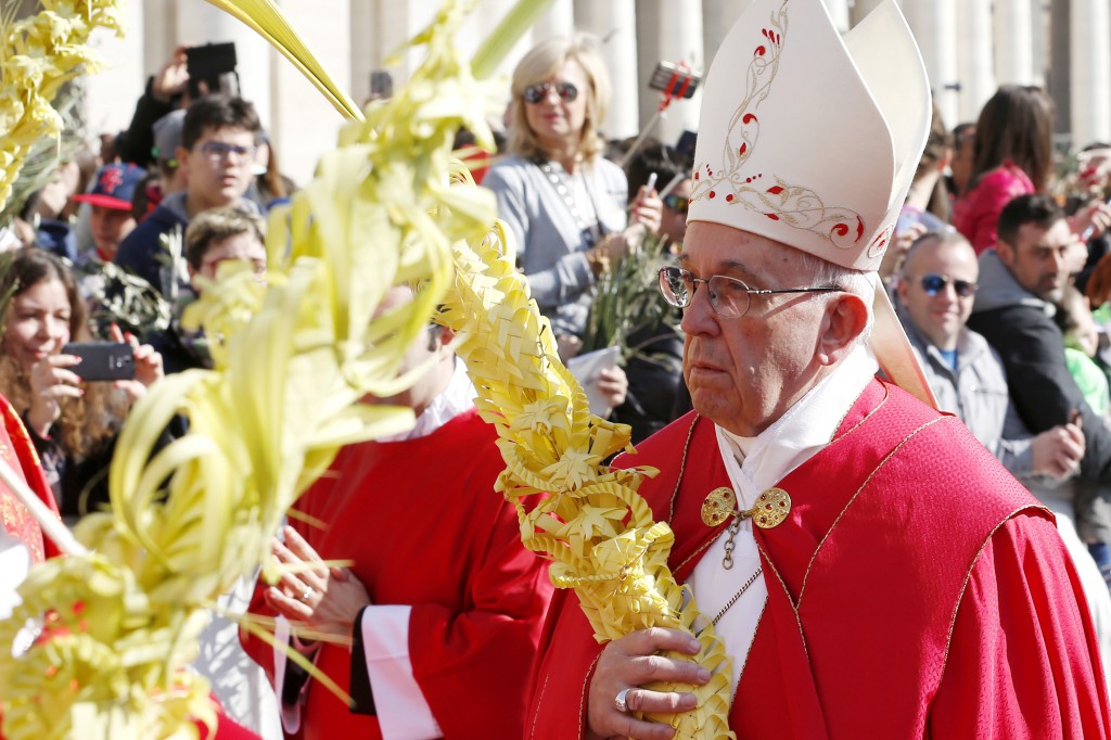 Pope Francis carries palm fronds in procession during Palm Sunday Mass in St. Peter's Square at the Vatican on 20 March. Photo: CNS.
