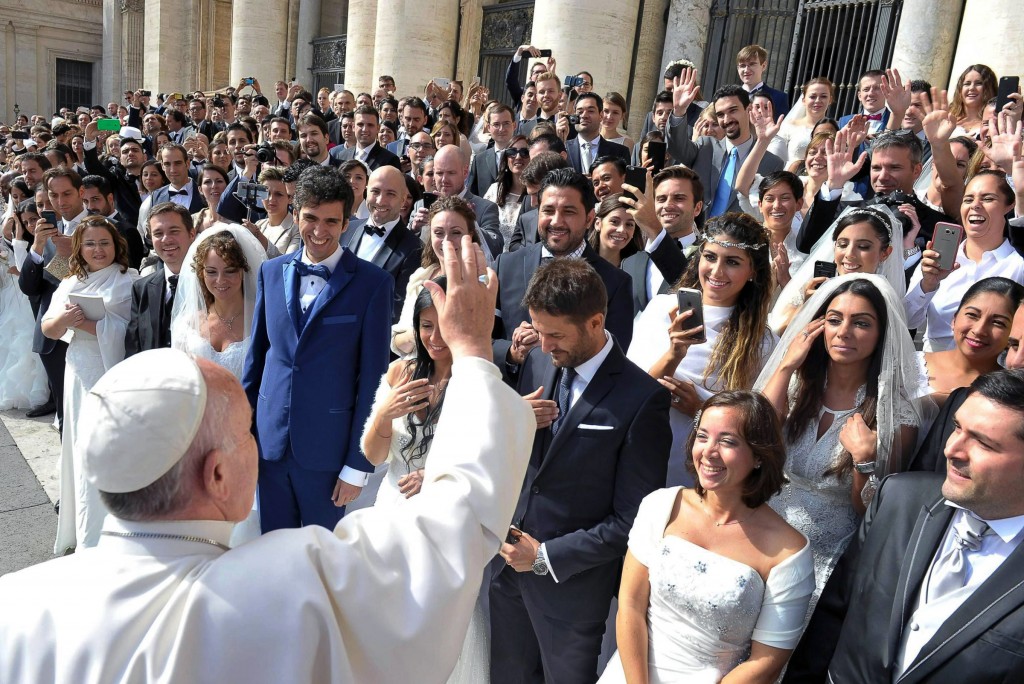 Pope Francis greets newly married couples during his general audience in St Peter's Square at the Vatican on 30 September 2015. Pope Francis' post-synodal Apostolic Exhortation on the family, Amoris Laetitia (The Joy of Love), was released on 8 April. The exhortation is the concluding document of the 2014 and 2015 synods of bishops on the family. Photo: CNS.