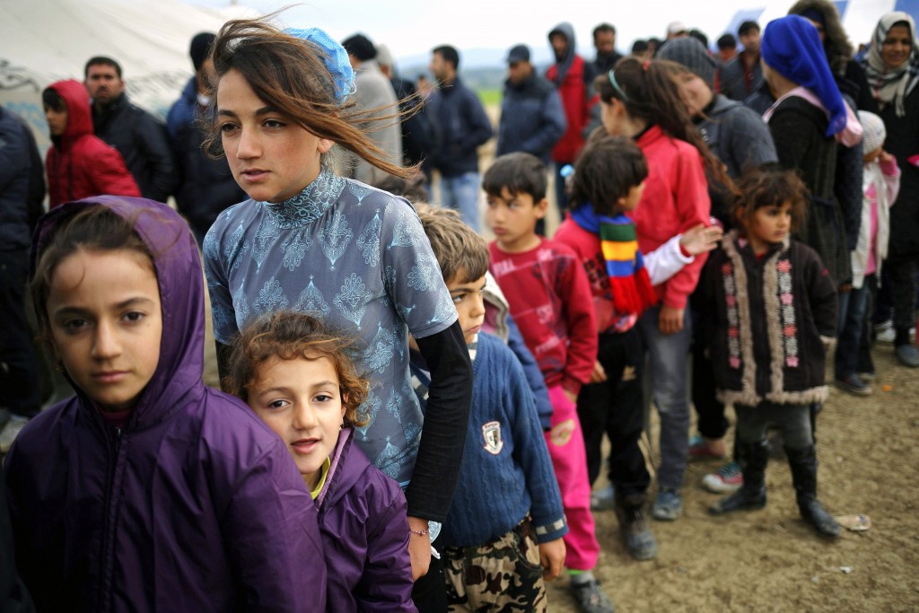 Young refugees wait in line for tea at a makeshift camp on April 11 at the Greek-Macedonian border near the village of Idomeni, Greece. Pope Francis will travel to Lesbos, Greece on April 16. Photo: CNS/Stoyan Nenov, Reuters.