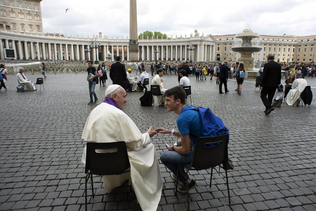 Pope Francis hears confession of a youth on 23 April in St Peter's Square at the Vatican. Photo: CNS/L'Osservatore Romano via Reuters