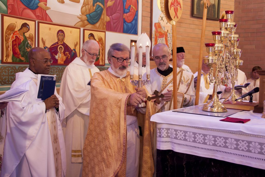 Newly ordained Fr Richard is led around the altar by Fr Wolodymyr. Fr Richard kissed the altar’s four corners, thus dedicating himself always to serve at the Holy Table. Photo: Marco Ceccarelli