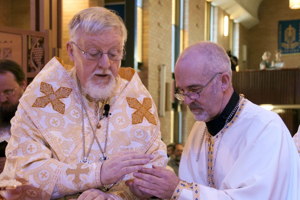 Bishop Peter Stasiuk CSsR gives the consecrated Body of Christ to the newly ordained Fr Richard at St John the Baptist Ukrainian Catholic Church on 3 April 2016. Photo: Marco Ceccarelli