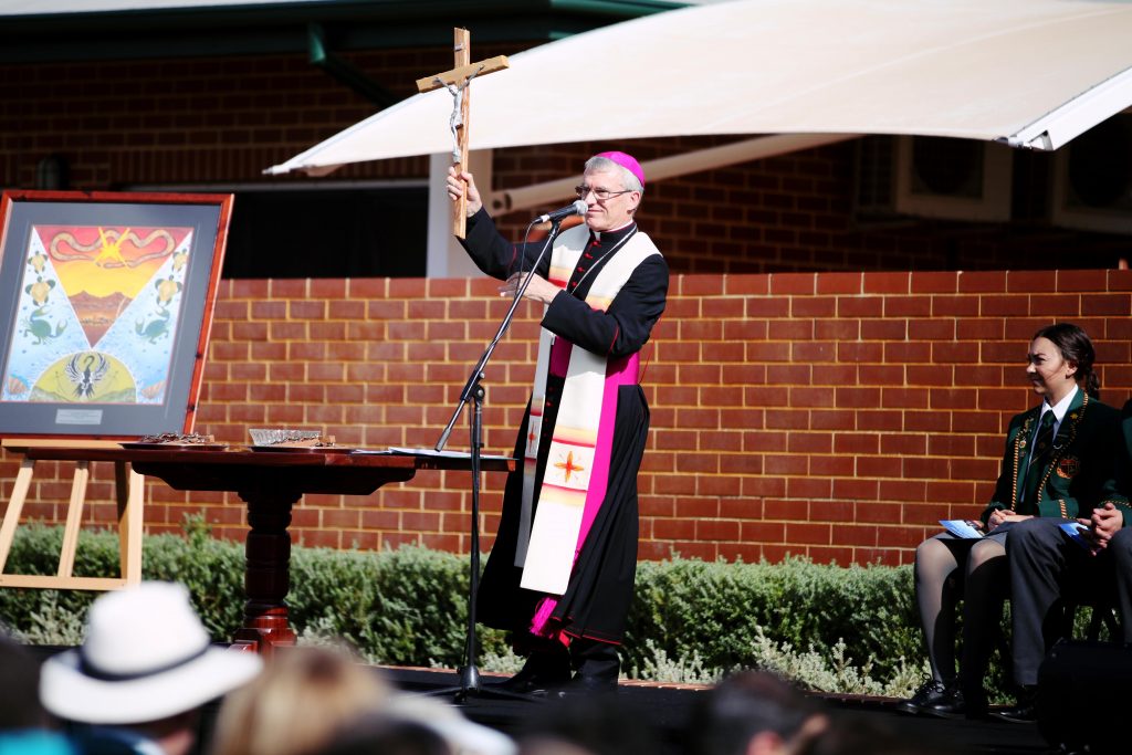 Archbishop Costelloe holds up the crosses before blessing them for the new Brother Fitzhardinge Trade Skills Centre at La Salle College, which was officially blessed and opened on Wednesday, 13 April. Photo: Jesse Roberts