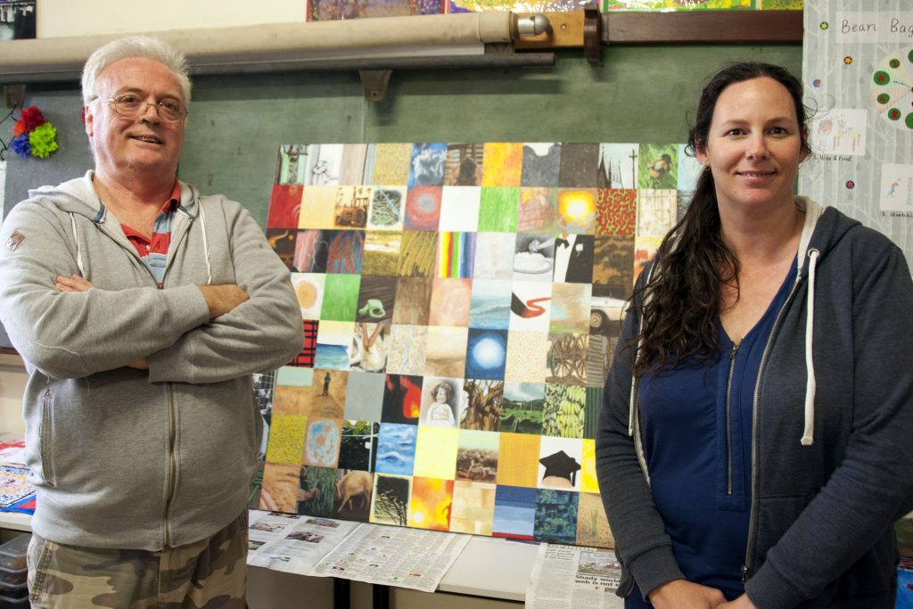 Goeff Scott and Emma Chevron stand in front of Geoff’s painting, Memories, in the arts and crafts room of Catholic Ministry for People who are Deaf or Hearing Impaired. Photo: Marco Ceccarelli