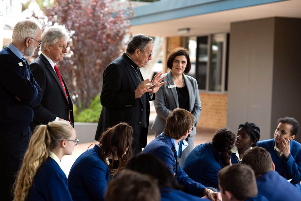 Cardinal Oscar Maradiaga SDB talks to St Norbert College students about the need for a fairer economic system, watched on by (L-R) Catholic Education WA Consultant, Peter Higgins; Acting Principal, Clem Mulcahy, and Deputy Principal, Natasha Quinn. Photo: Chris Richards-Scully