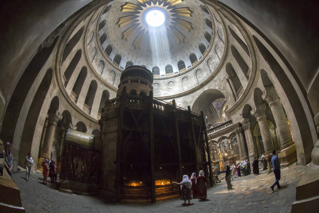 Tourists and Christian pilgrims visit the tomb where it is believed Christ was buried inside the Church of the Holy Sepulchre in Jerusalem. Photo: CNS/Jim Hollander, EPA
