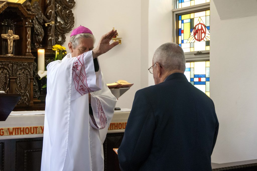 Trevor Knuckey receives a blessing from Emeritus Archbishop Barry Hickey, after making private vows to live in service to Our Lady. Photo: Rachel Curry