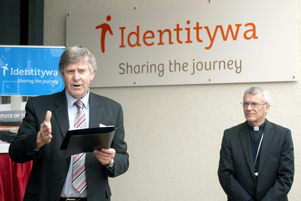 Identitywa Board Chair Graeme Mander addresses attendees at the Blessing and Official Opening ceremony of Identitywa’s new office in Cockburn, as Perth Archbishop Timothy Costelloe SDB looks on. Photo: Rachel Curry