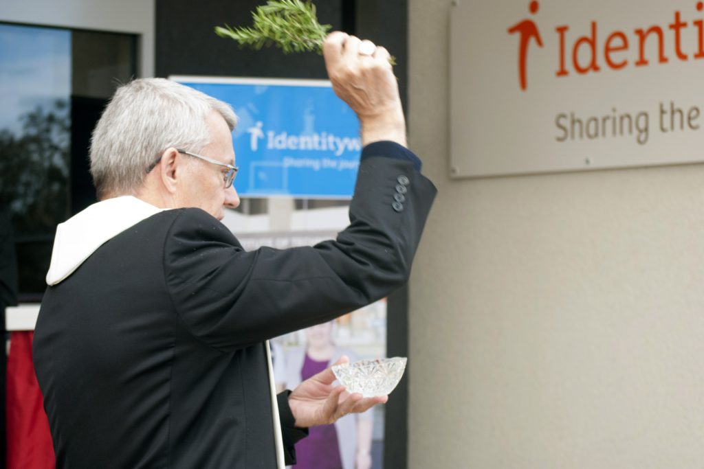 Perth Archbishop Timothy Costelloe SDB sprinkles holy water on Identitywa’s new Cockburn Office as part of the Blessing and Official Opening ceremony on Friday, August 19. Photo: Rachel Curry