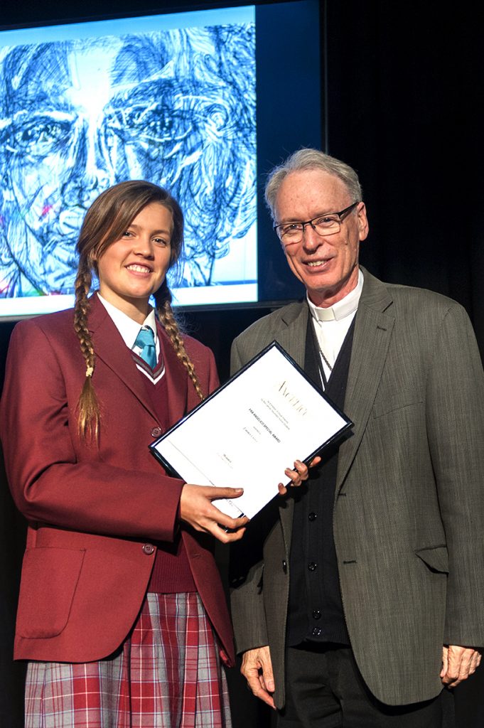 Year 12 student Emma Craig, from St Mary MacKillop College in Busselton, is presented with the Fra Angelico Award by Auxiliary Bishop of Perth, Don Sproxton. Emma’s winning piece, Perspective, can be seen in the background. Photo: Supplied