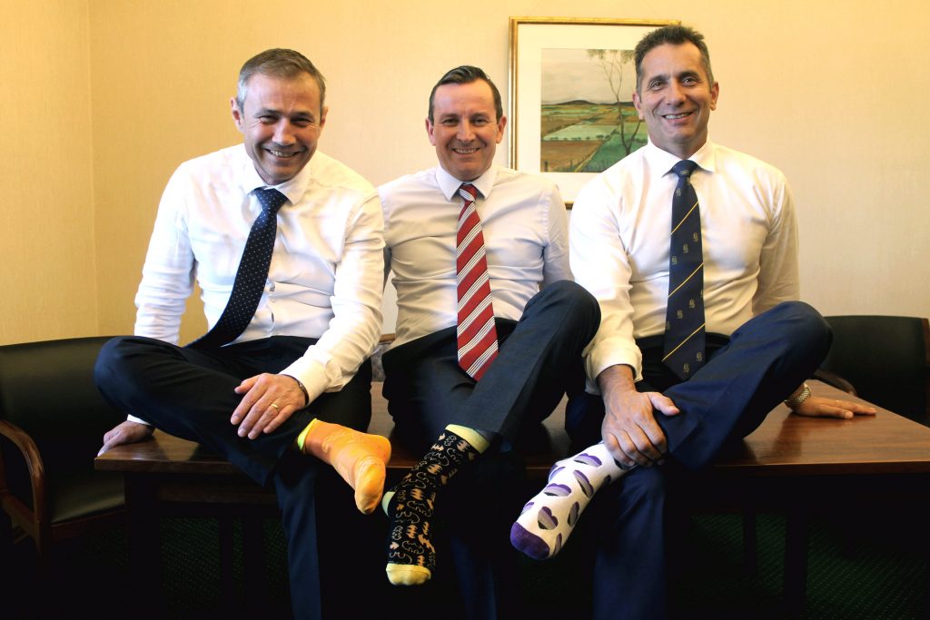 MPs Mark McGowan, Paul Papalia and Roger Cook show their support to Catholic Mission’s Socktober initiative by wearing ‘our of the ordinary’ colourful socks. Photo: Supplied